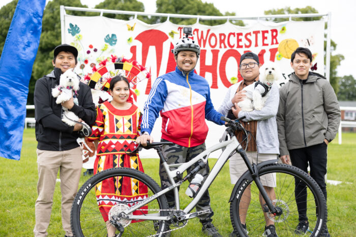 Five members of Worcester England Filipino Association standing in front of the Worcester Show banner